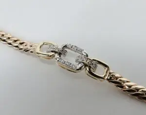 Gold chain with diamond-studded clasp.