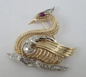 Gold and silver bird-shaped brooch.