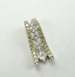 Crossed diamond and yellow gemstone pendant.