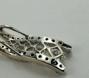 Silver jewelry piece with geometric design.
