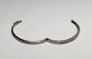 Silver bracelet with crystal accents on display.