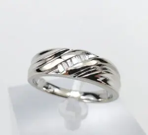 Silver ring with geometric design on display.