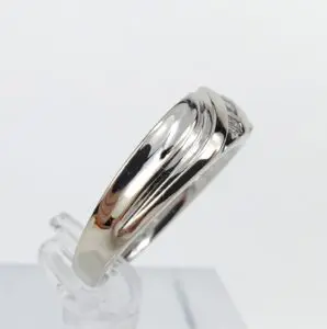 Silver ring with subtle engraved design.