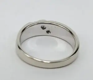 Silver ring with two small stones inside.