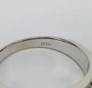 Silver ring with 'HDS' engraving inside.