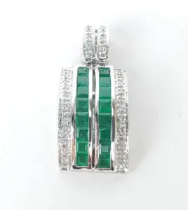 Silver pendant with green gemstones and diamonds.