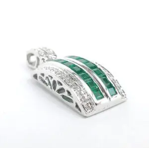 Silver pendant with green and clear stones.