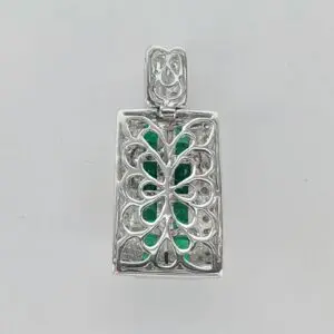 Silver pendant with green gemstone inlay.