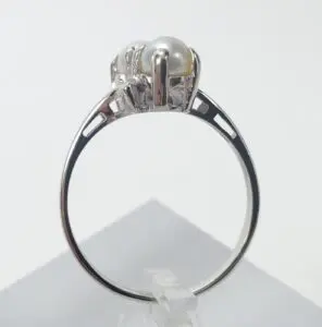 Silver ring with pearl adornment.