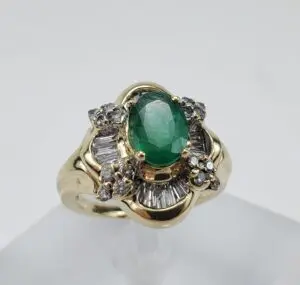 Gold ring with emerald and diamonds.