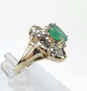 Gold ring with emerald and diamonds.