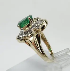 Gold ring with emerald and diamonds.
