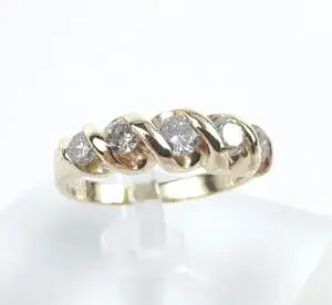 Gold ring with diamond accents displayed elegantly.