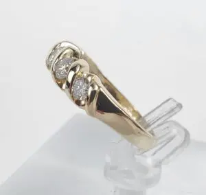 Gold ring with three diamond stones.