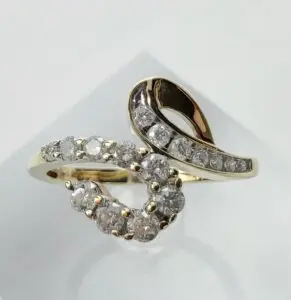 Gold ring with diamond swirl design.