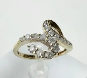 Gold and diamond swirl design ring.