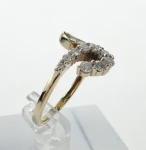 Gold ring with diamond accents on display.