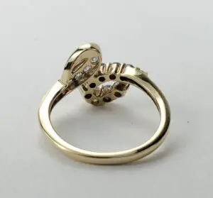 Gold ring with diamond accents, back view.
