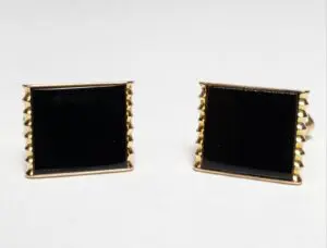 Gold square cufflinks with black enamel.