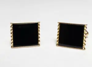 Gold and black square cufflinks.