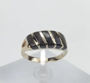 Gold ring with black striped design.