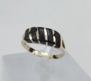 Gold ring with black striped design.
