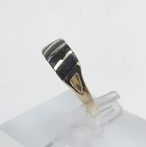 Gold and silver ring on display stand.