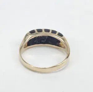 Gold ring with black enamel details.