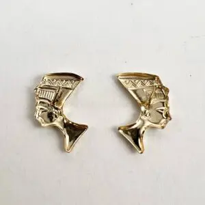 Gold Nefertiti silhouette earrings on display.