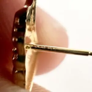 Close-up of a gold earring post.