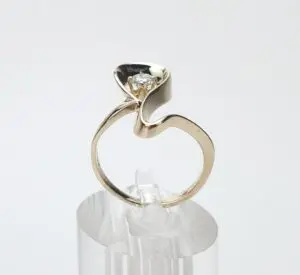Unique gold ring with diamond setting.