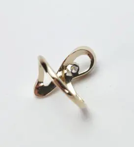 Gold ring with a single diamond accent.