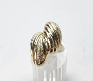 Gold ring with ribbed design and diamonds.