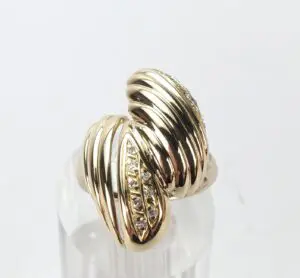 Gold ring with ribbed design and diamonds.