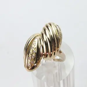 Gold ring with ribbed design and diamonds.