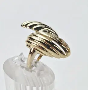 Gold spiral ring on clear display stand.