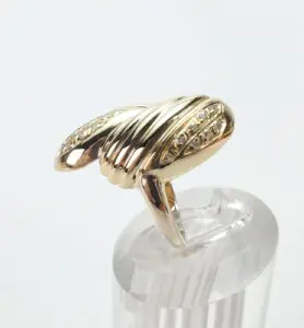 Gold ring with diamond accents on display.