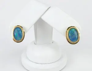 Gold earrings with blue opal stones.