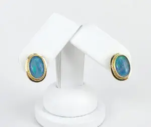 Gold earrings with oval blue opals.