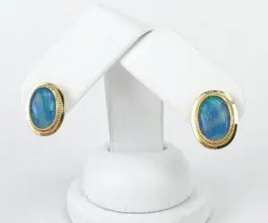 Gold earrings with blue opal stones.