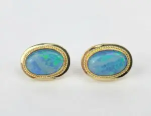 Opal earrings with gold oval settings.