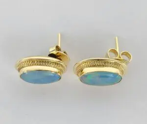 Gold earrings with blue gemstones.