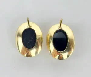Gold oval earrings with black stones.