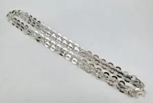 Silver chain necklace on white background.