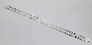 Silver chain necklace on white background.