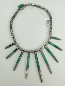 Silver and green beaded necklace with spikes.
