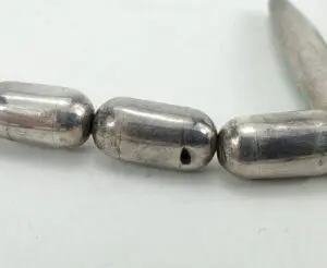 Silver metal beads on a string.