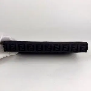 Black embossed rectangular item on white background.