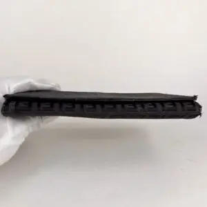 Black book held by gloved hand.