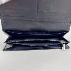 Open black leather wallet with zipper compartment.
